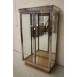 AN ART DECO OAK DISPLAY CABINET of oblong form with two doors having ring handles, the interior with