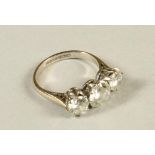 A THREE STONE DIAMOND RING, the central brilliant cut stone of approximately 1.40cts flanked by a