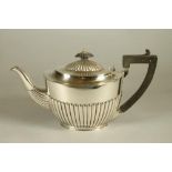 A LATE VICTORIAN SILVER TEAPOT, makers D & J Wellby, London 1899, of semi fluted oval form, the