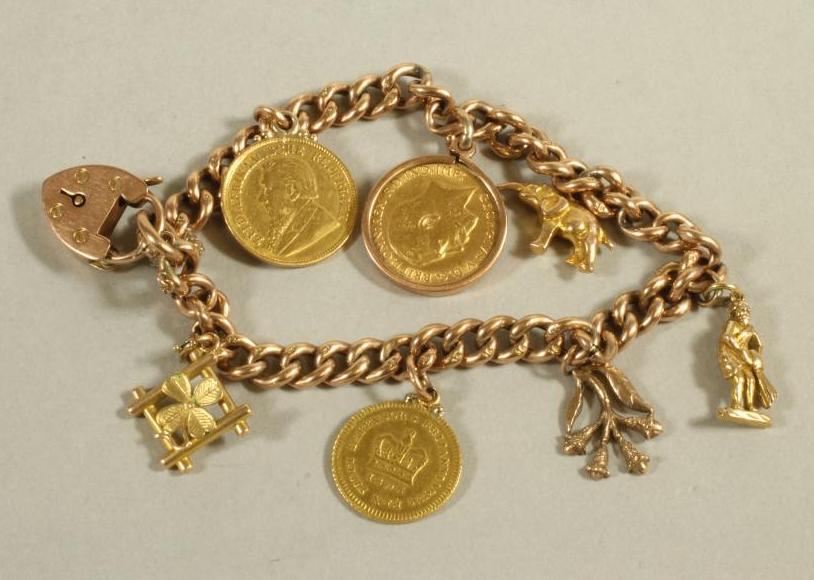 A GEORGE V GOLD HALF SOVEREIGN, 1912, loose mounted in 9ct gold as a charm fixed to a 9ct gold