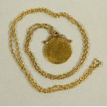 A GEORGE III GOLD SPADE GUINEA, 1781, hard mounted in a scroll pendant setting on a 9ct gold chain