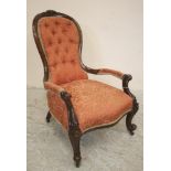 A VICTORIAN WALNUT FRAMED SALON CHAIR of spoonback form, button upholstered in terracotta brocade,