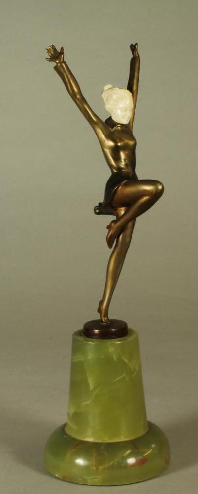 AN ART DECO BRONZE FIGURE OF A YOUNG FEMALE with carved ivory head, standing on her left leg with - Image 2 of 4