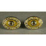 A PAIR OF YELLOW SAPPHIRE SET CUFFLINKS, the oval panels centred by a collet set stone on a yellow