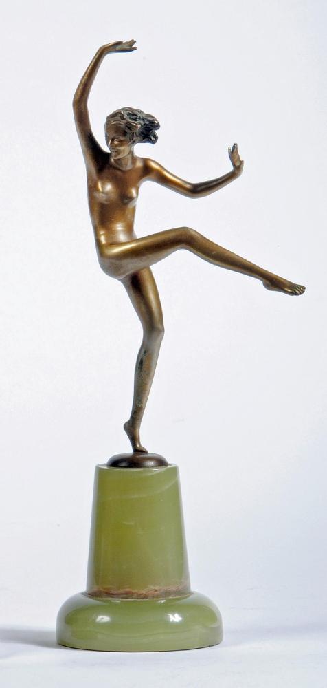 AFTER LORENZL - An Art Deco bronze figure of a young female nude, standing on her left leg with arms