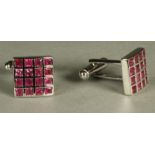 A PAIR OF RUBY SET CUFFLINKS, the square panels bezel mounted with sixteen square cut small rubies