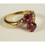 A RUBY AND DIAMOND RING, the two facet cut tear shaped rubies claw set in a crossover type