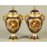 A PAIR OF COALPORT CHINA VASES AND COVERS, early 20th century, of ovoid form, the two angular reeded