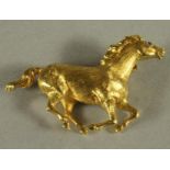 AN 18CT GOLD BROOCH, cast as a galloping horse with a sapphire eye, London 1965, sponsor's mark