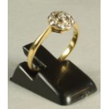 A DIAMOND CLUSTER RING, the central brilliant cut stone within a border of eight similar smaller