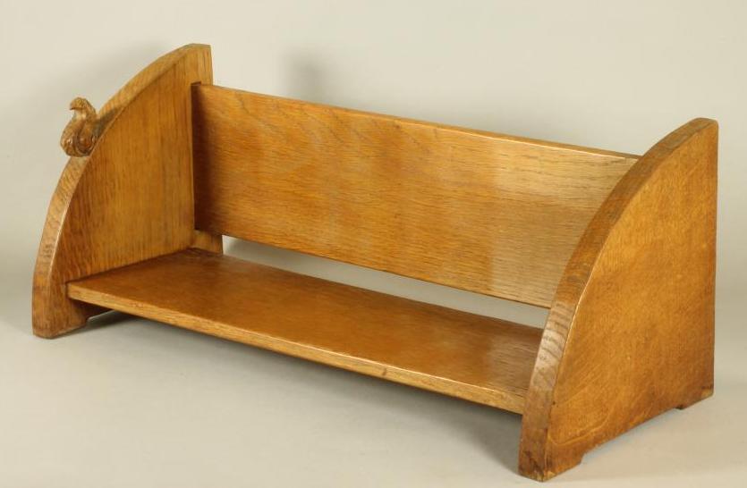 A WILF HUTCHINSON ADZED OAK BOOK TROUGH, the quadrant ends with carved squirrel trademark in high