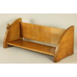 A WILF HUTCHINSON ADZED OAK BOOK TROUGH, the quadrant ends with carved squirrel trademark in high