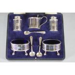 A FIVE PIECE SILVER CRUET, makers Martin, Hall & Co., Birmingham 1919, of cylindrical form pierced