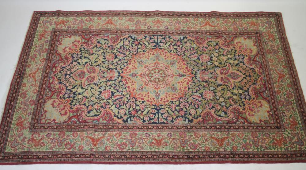 A KERMAN RUG, the navy blue field with foliate scrolls centred by a raspberry flowerhead gul, - Image 2 of 6