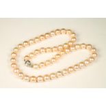 A SINGLE STRAND PINK CULTURED PEARL NECKLACE with an 18ct white gold ribbed spherical clasp