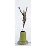AN ART DECO BRONZE FIGURE OF A YOUNG FEMALE with carved ivory head, standing on her left leg with