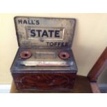 Hall's State toffee tin with lid opening to inkstand, 2 ceramic wells, and a pen all decorated in