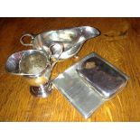 Two silver creamers and two silver cigarette cases