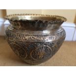 Eastern brass planter with foliate decoration and eastern figures