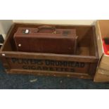 Vintage crate advertising Player's Drumhead Cigarettes and a leather suitcase