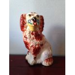 A 19th c Staffordshire dog with basket in mouth 20cm high