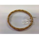 A 9ct gold hinged bangle 9.5 gms