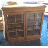 A 19th c glazed pine cupboard