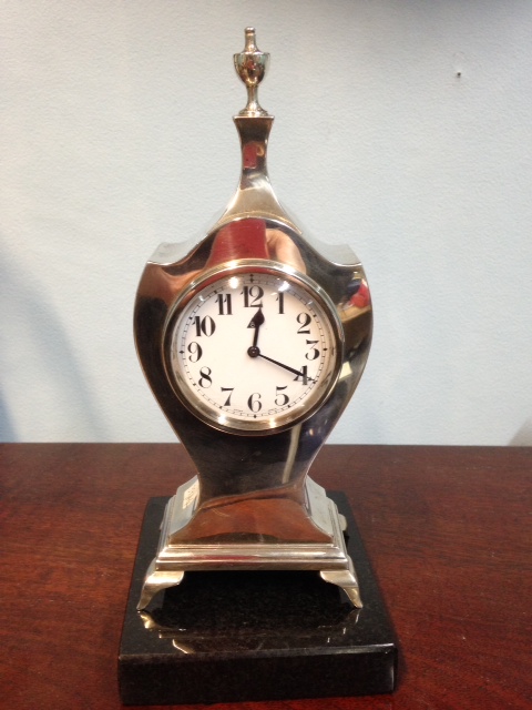 A small silver mantle clock B'ham 1921