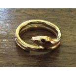 An18ct gold snake ring with ruby eyes 7.8 gms size W\X