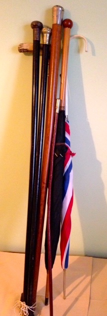 Two umbrellas, 4 walking sticks and a swagger stick