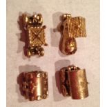 Four 9ct gold charms