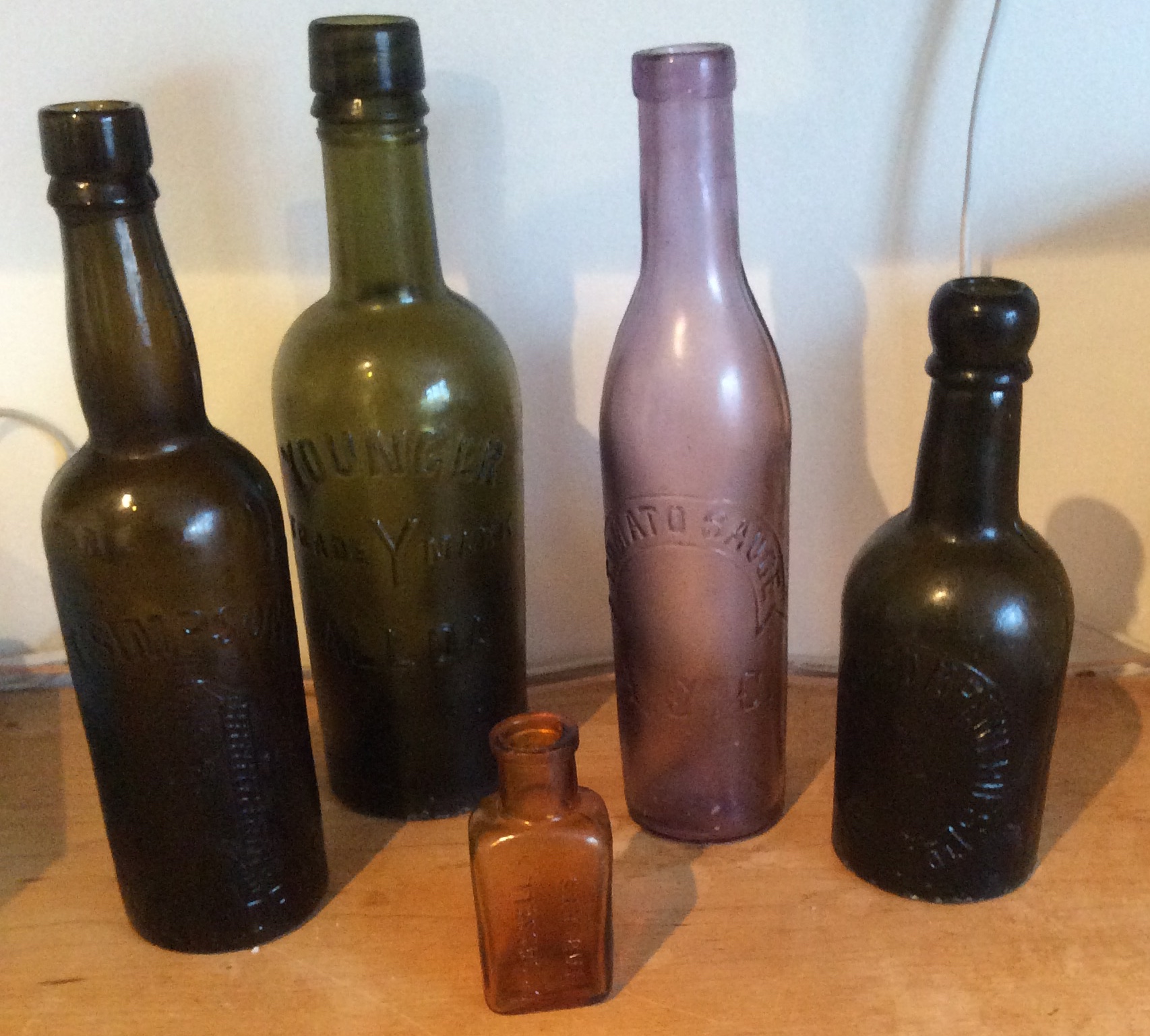 Five coloured named chemist bottles