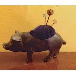 Base metal pincushion in the form of a pig and three pins