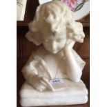 White marble figure of a young girl reading a book inscribed A B