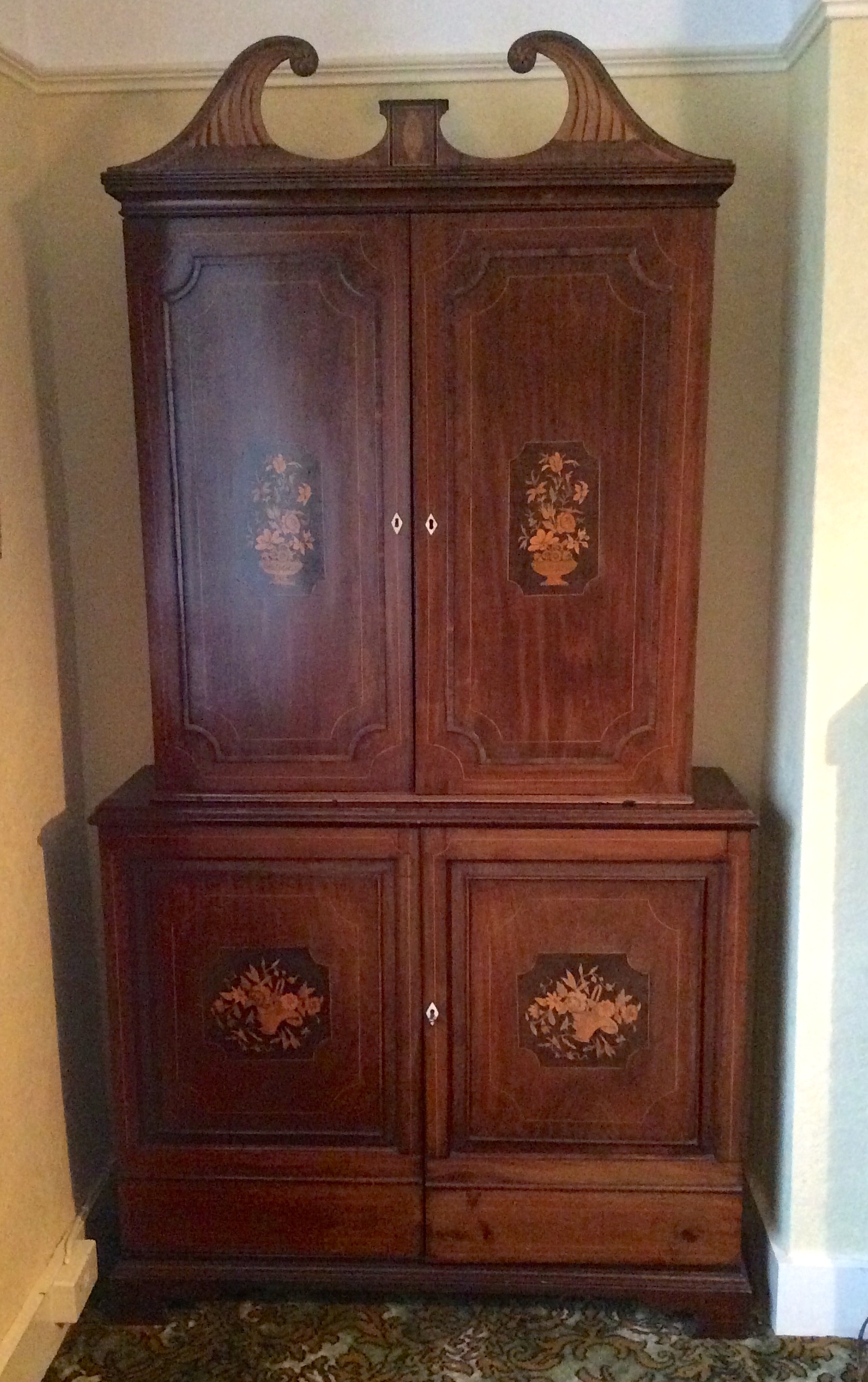 An 18th c cabinet on later base the whole with later floral