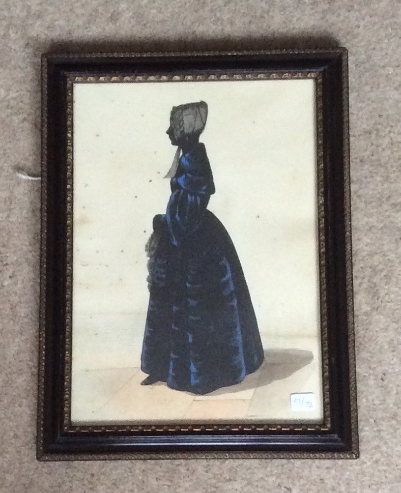 A good silhouette of a lady in a blue gown worm holes to paper but not on the subject