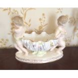 A 19th creamware bowl with two cherub supports