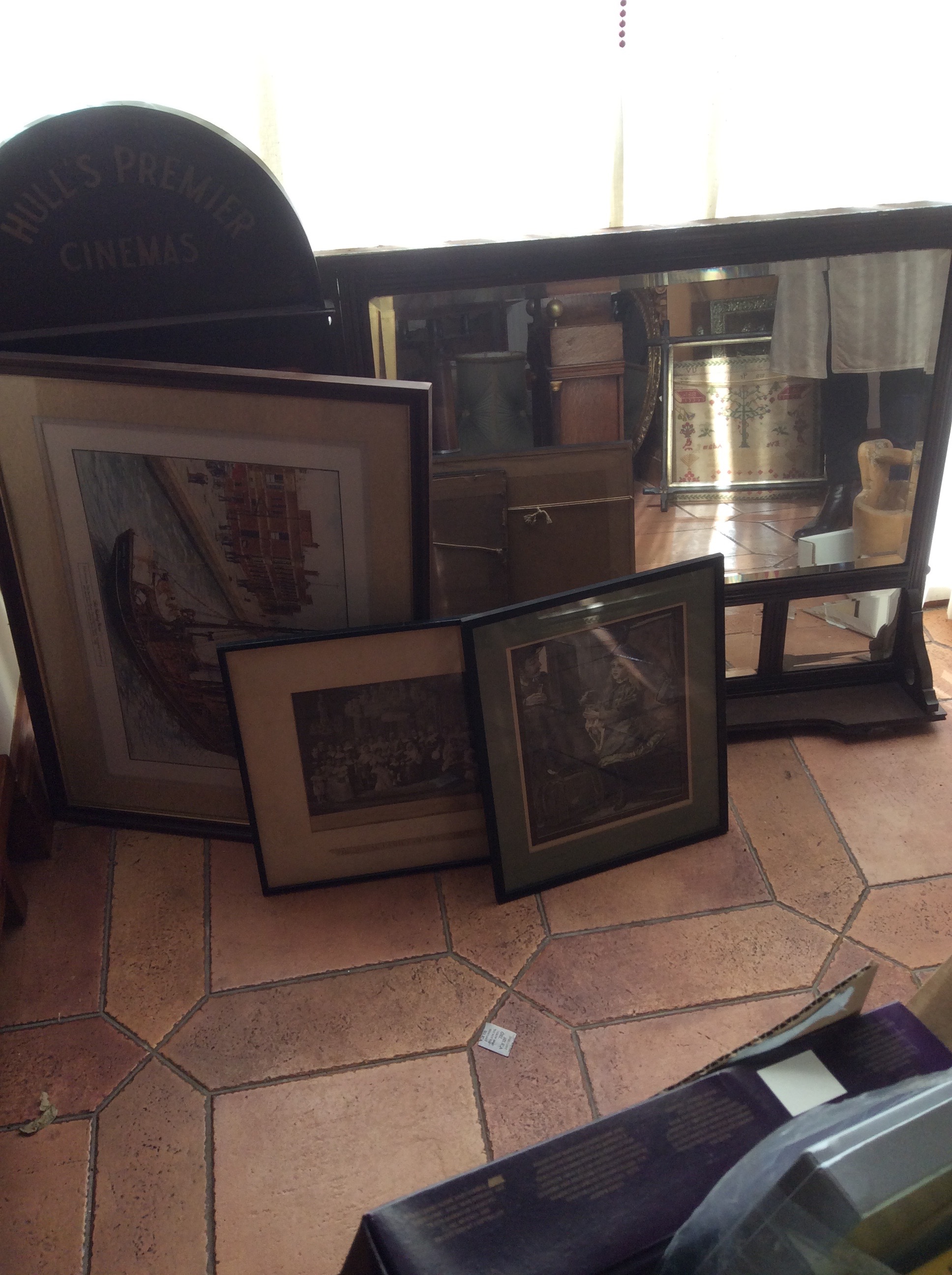 An overmantle mirror, three prints and a Hull Cinema notice board