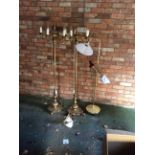 Three brass floor lamps