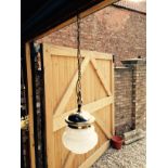 Circular milk glass shade with brass fittings.