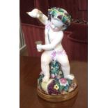 Good quality continental porcelain figure of a Bacchanalian cherub