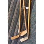 Three hickory shafted golf clubs.