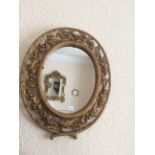 Pair of small oval gilt mirrors