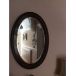 Oval mahogany bevel edged wall mirror