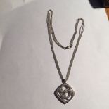 An 18ct white gold pendant and chain 12.9 gms