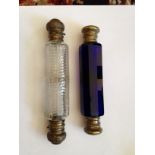 Double ended blue glass scent bottle and a clear glass double ended bottle