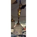 Small hanging brass light with frosted glass shade.