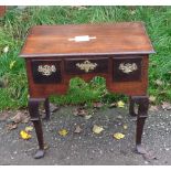 An 18th c oak lowboy with replacement top