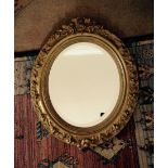 Oval gilt bevel edged wall mirror (overpainted)