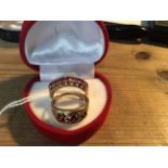 A 9ct gold and garnet dress ring O/P and another similar